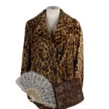 An Astraka faux leopard skin coat c1950 together with a crocodile skin handbag and a lace fan