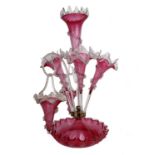 A Victorian cranberry glass epergne with two hanging baskets. 52cm(h).Missing one vase.