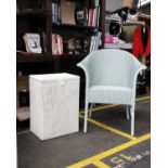 A mint green Lloyd Loom tub chair together with a Lloyd Loom laundry basket.