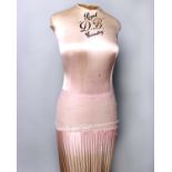 A 1930s Royal DB silk covered corsetry mannequin, with a pink gathered silk skirt on a wooden stand