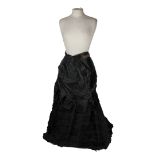 A Victorian black floor length bustle skirt, with ruching detail