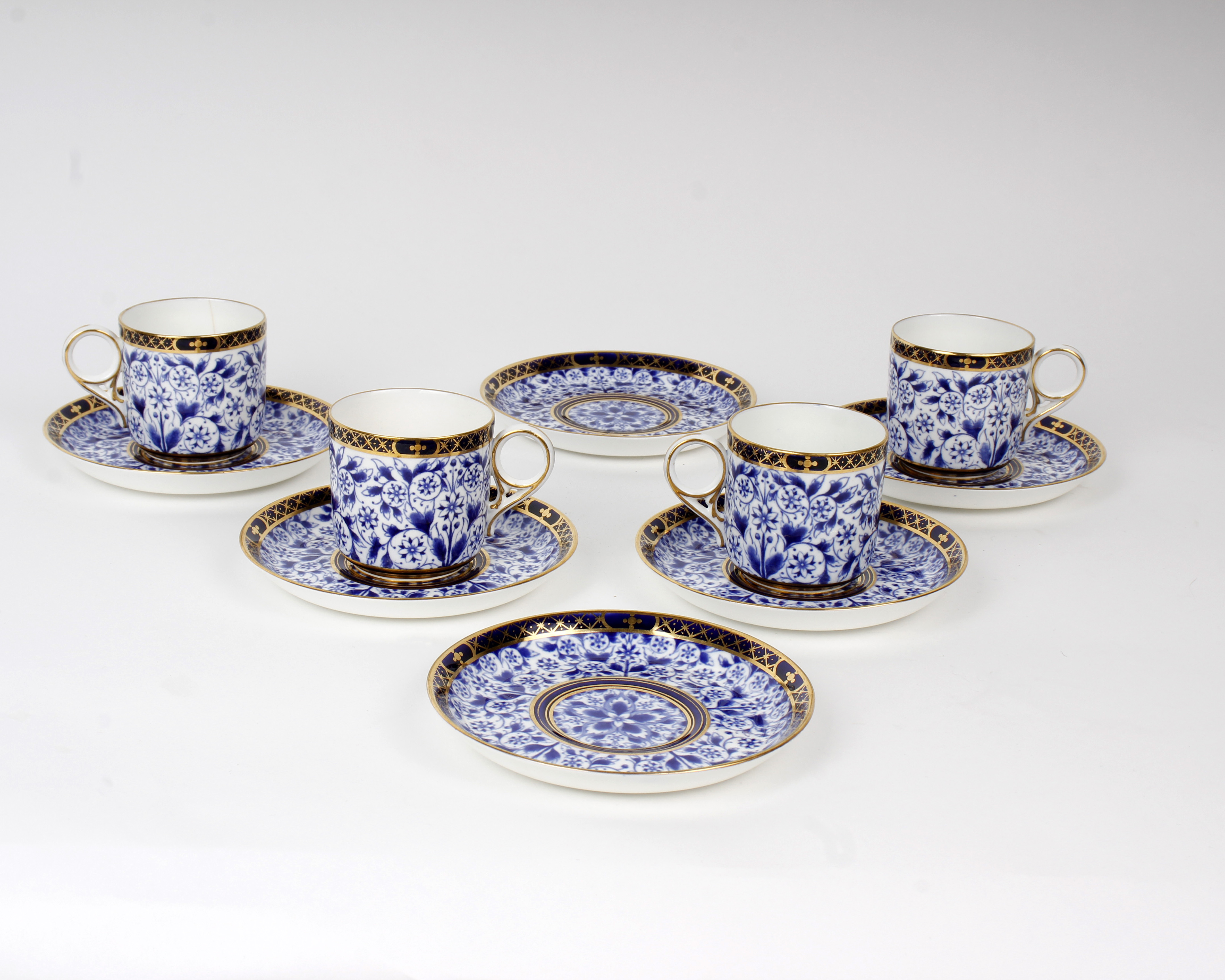 A set of four Royal Crown Derby coffee cans and saucers, plus 2 saucers, blue/white floral