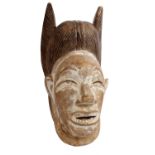 A 'Senofe' tribe carved softwood ceremonial masks with traces of lime wash paint