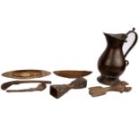 Two African wooden fishing spools together with other wooden utensils plus a copper jug