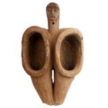 A carved softwood two section vessel of figure form overall ochre stained. 62cm(H) 40cm(W)