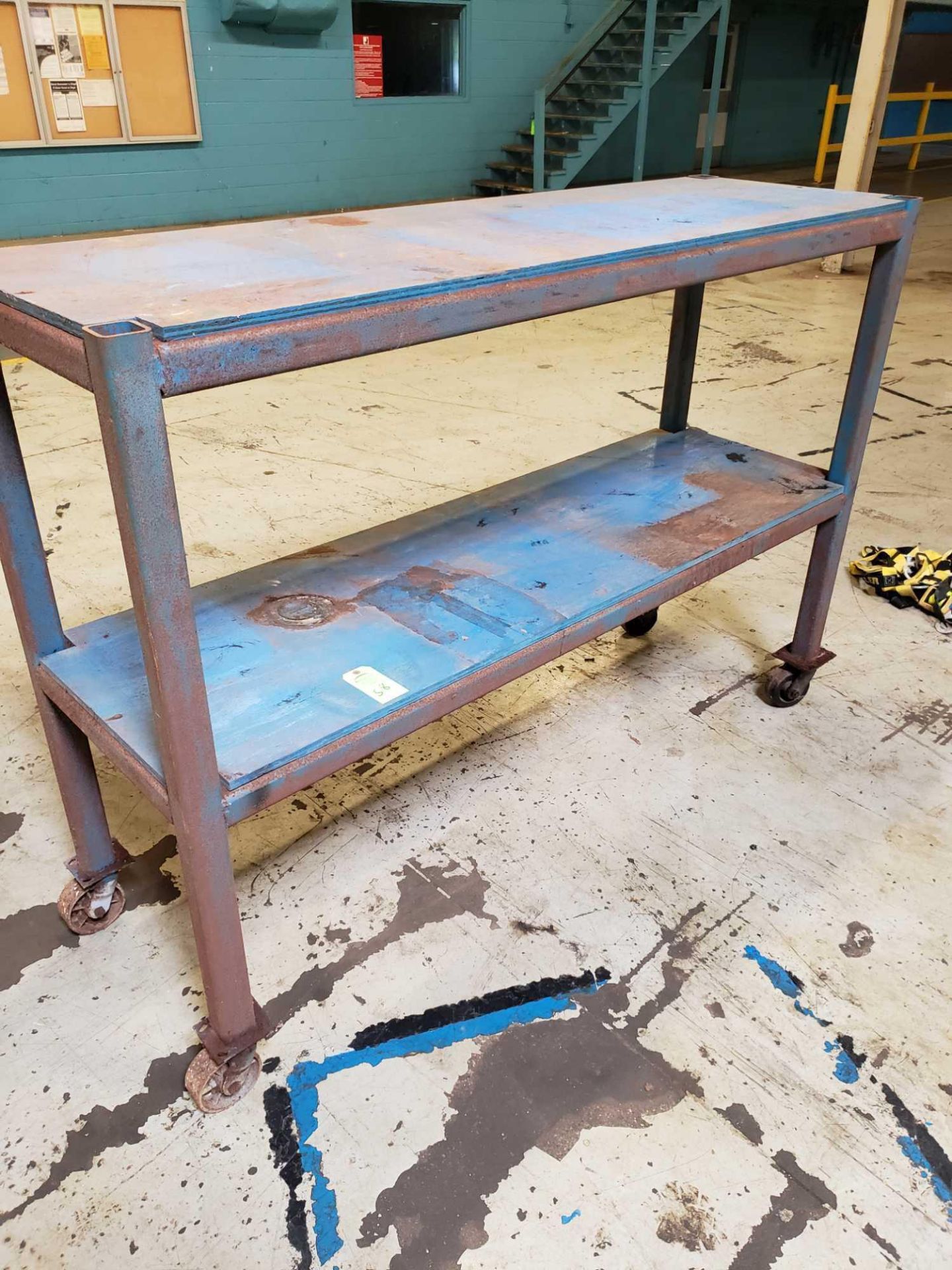 2' W 6 1/2' L 4 1/2' T steel table on casters.