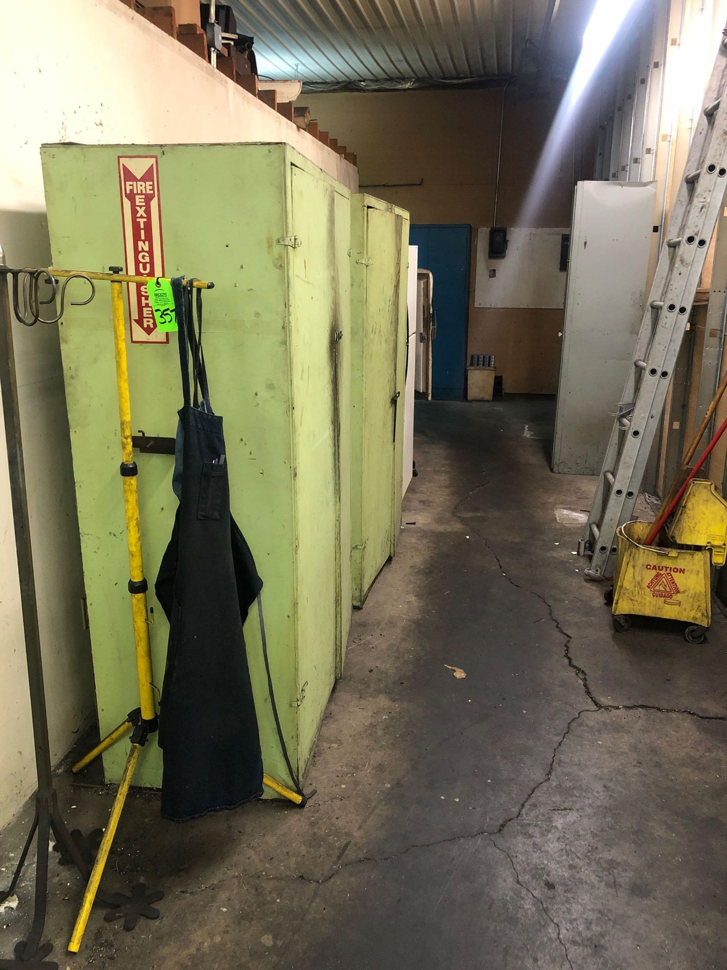 Contents of hallway including cabinets, coat trees, refridgerators, extension ladder, mop bucket etc