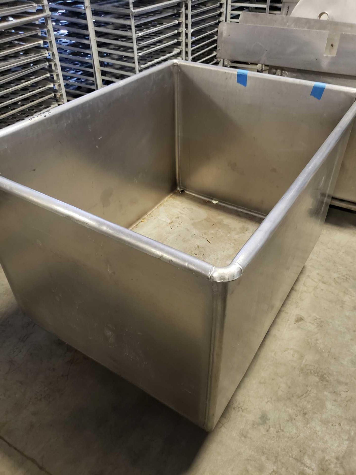 Stainless steel tank on casters with drain. Approx 49" wide by 38" deep by 30" tall. - Image 5 of 5