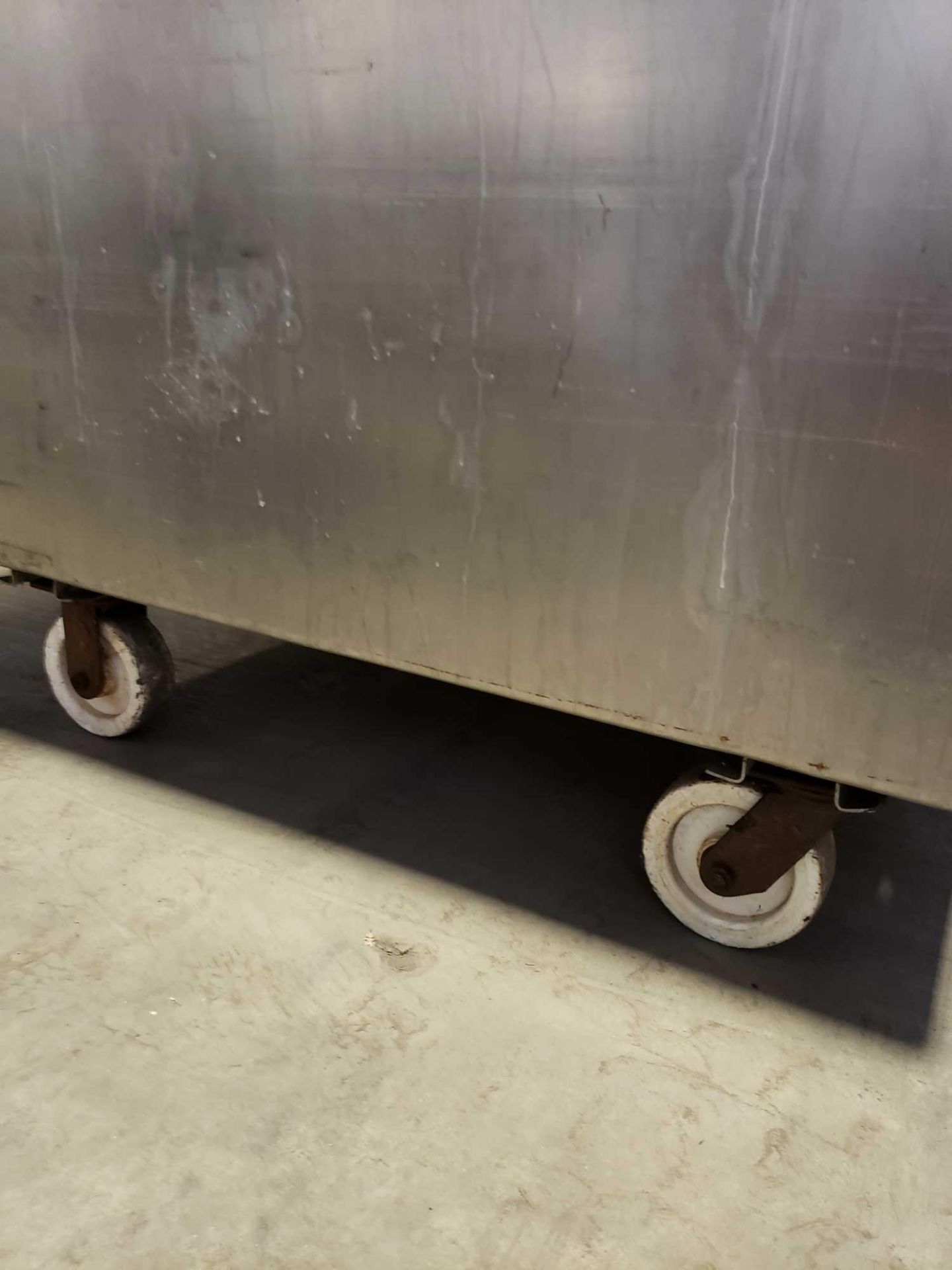 Stainless steel tank on casters with drain. Approx 49" wide by 38" deep by 30" tall. - Image 4 of 5