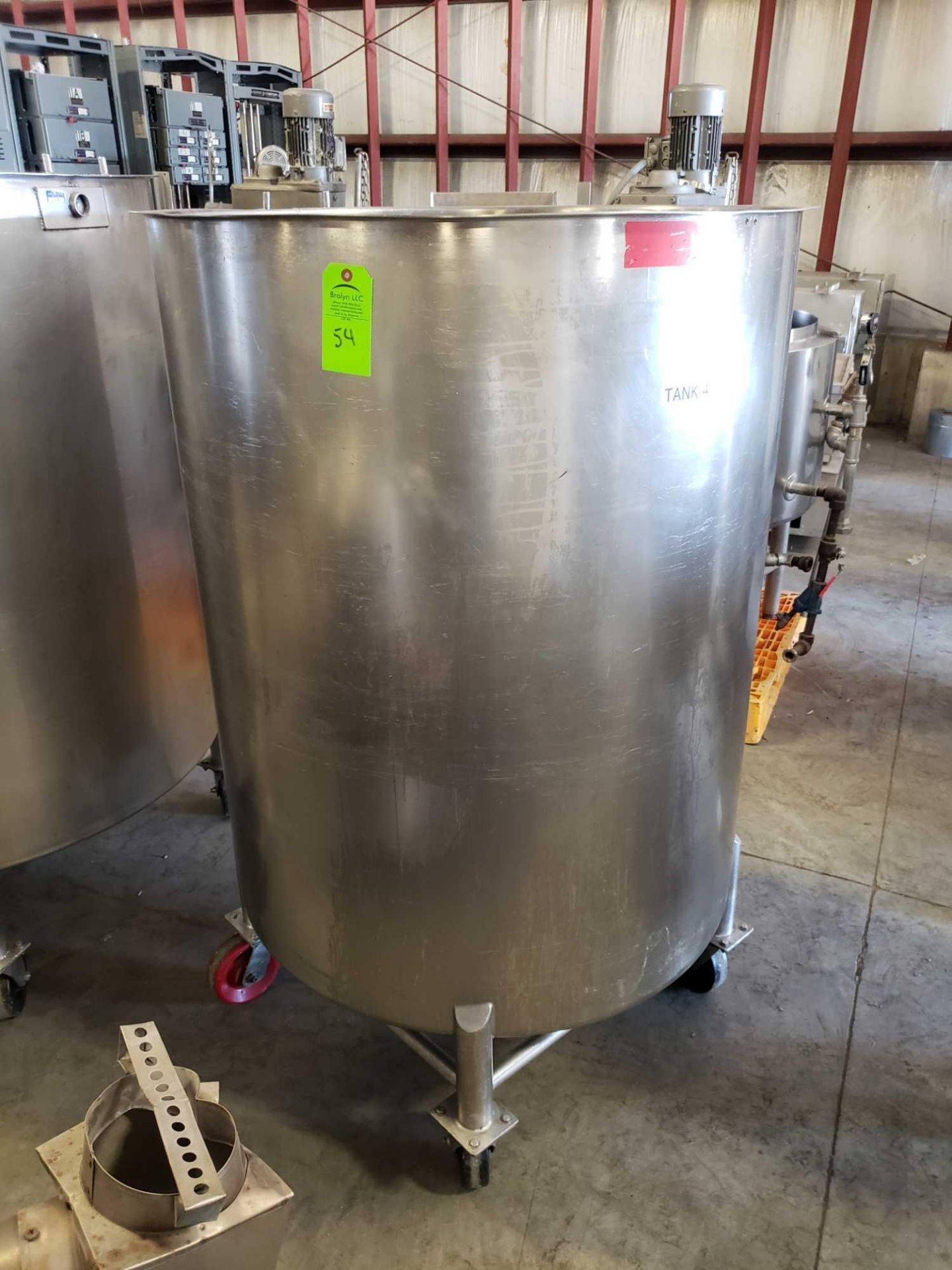 Stainless steel tank on casters. 40" diameter x 48" interior depth with lid inside. Est 250 gallon