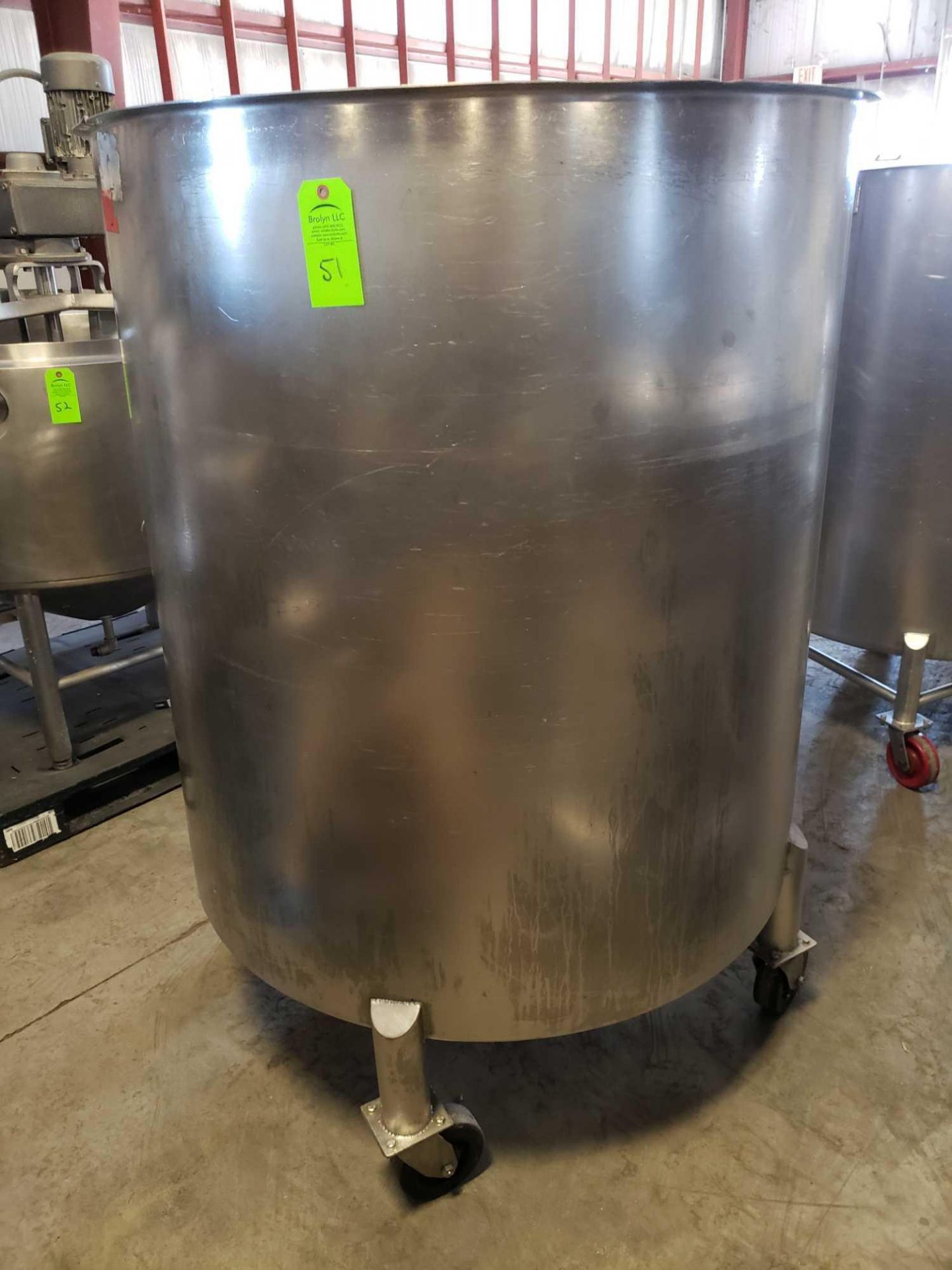 Stainless steel tank on casters. 45" diameter x 48" interior depth with lid inside. Est 250-300gal