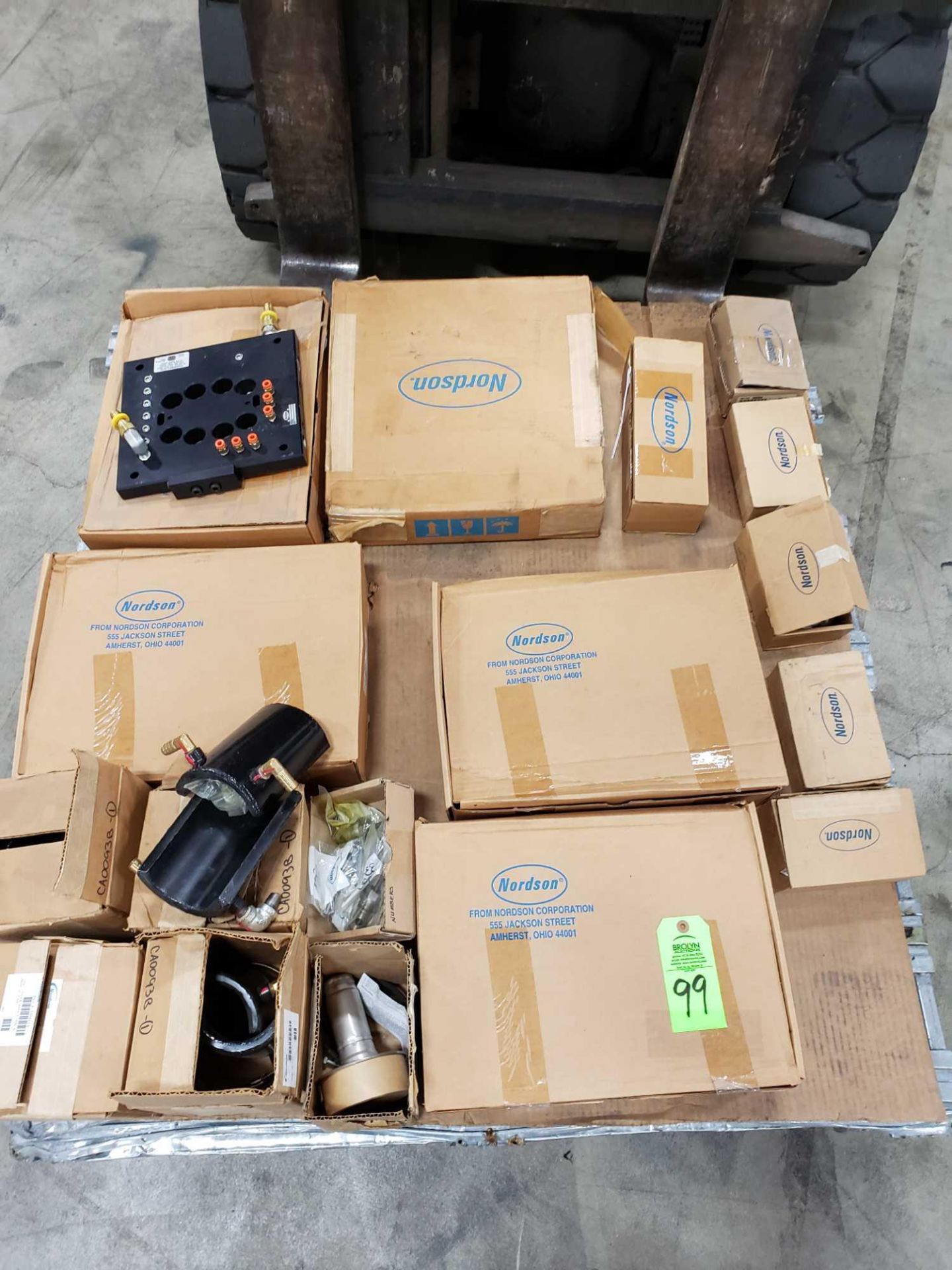 Pallet of assorted Nordson parts new in boxes.