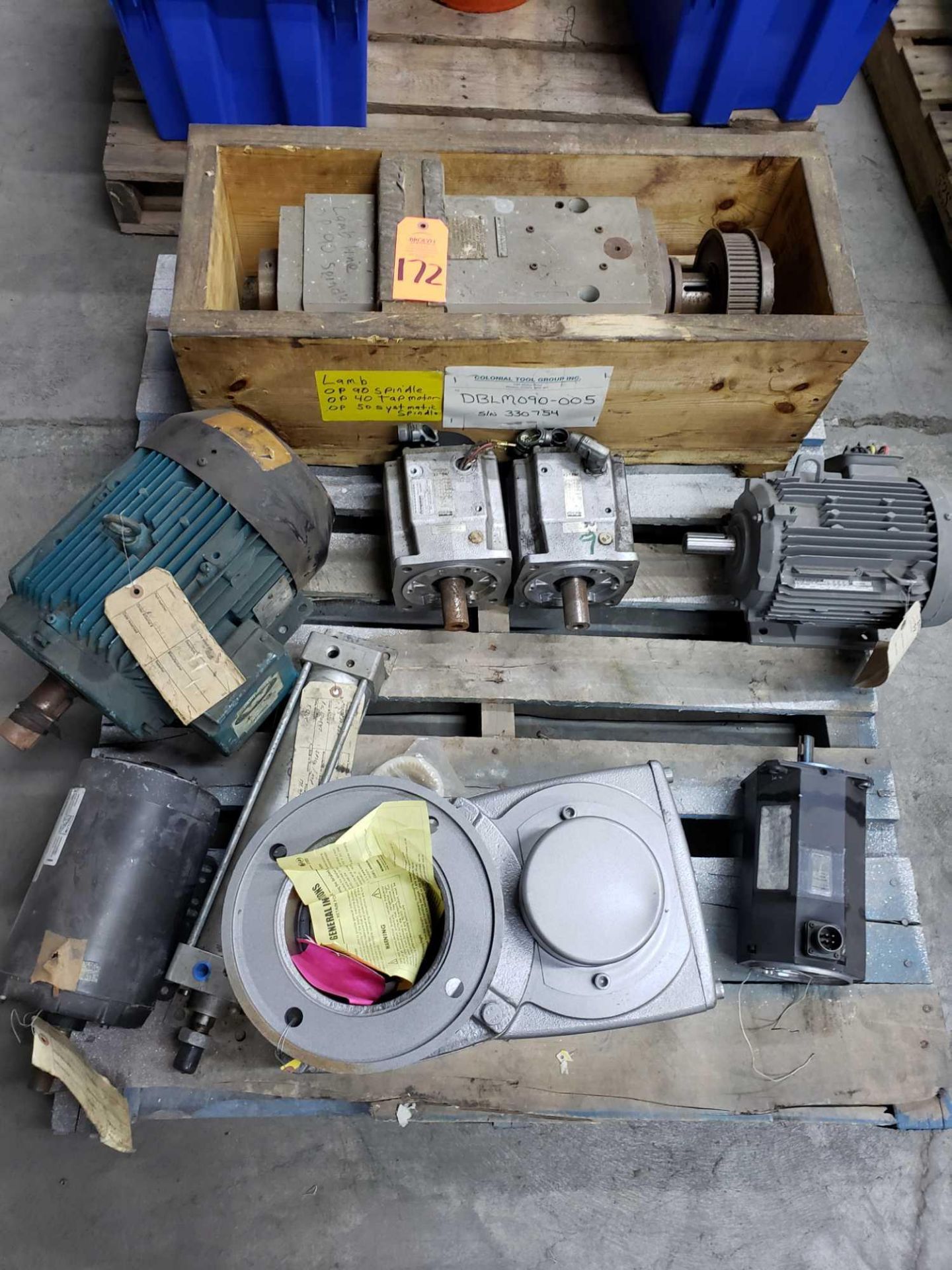 Pallet of assorted motors, gearboxes, and spindle assembly.