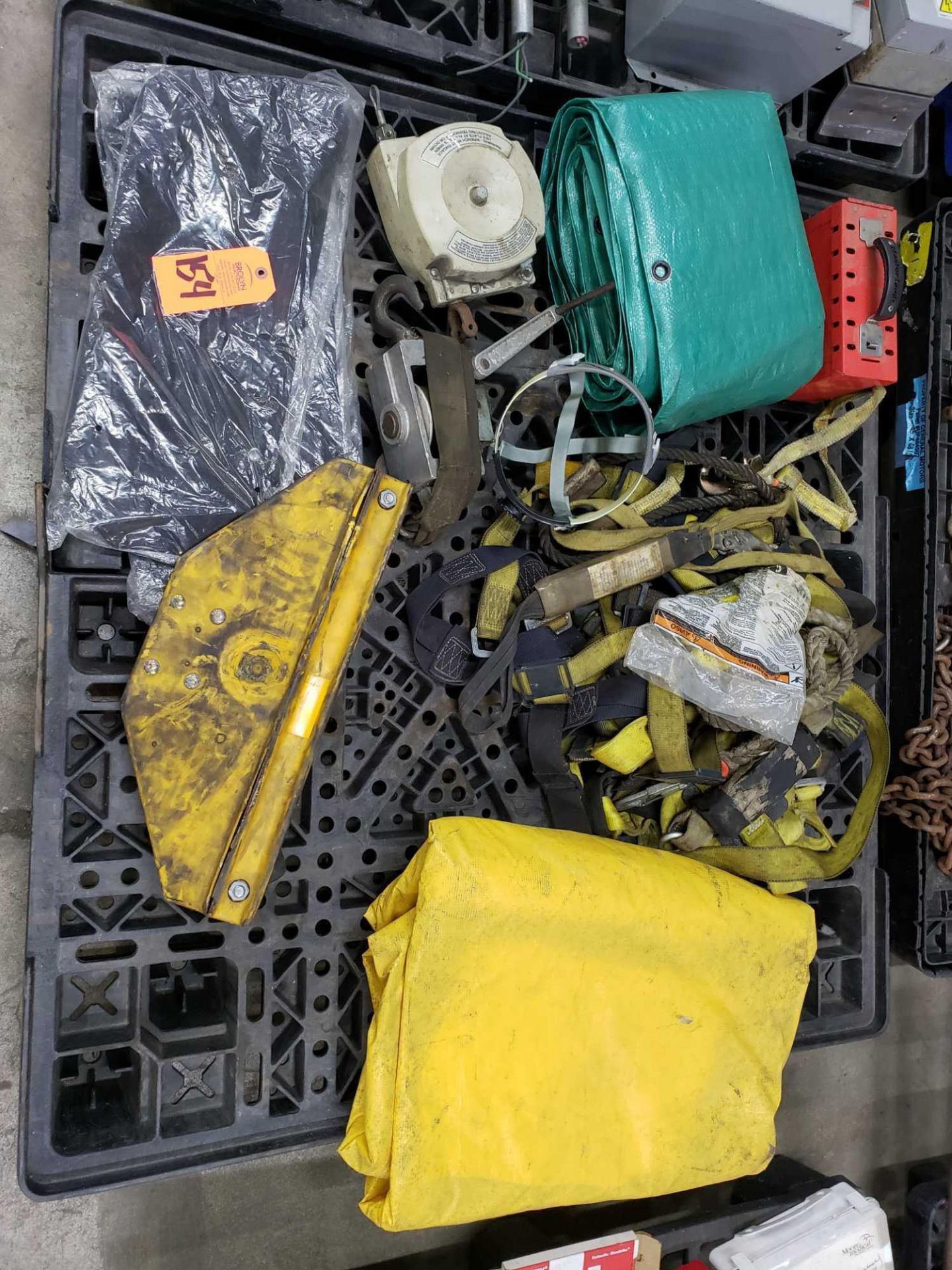 Pallet of assorted safety harnesses, tarps, and more.