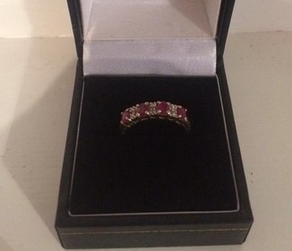 An Unmarked Gold Ladies Diamond and Ruby Dress Ring, Set with four rubies and three diamonds, ring - Image 2 of 2