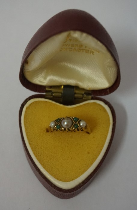 A 9ct Gold Pearl and Gem set Ring, With a large pearl flanked with a smaller pearl, and four small