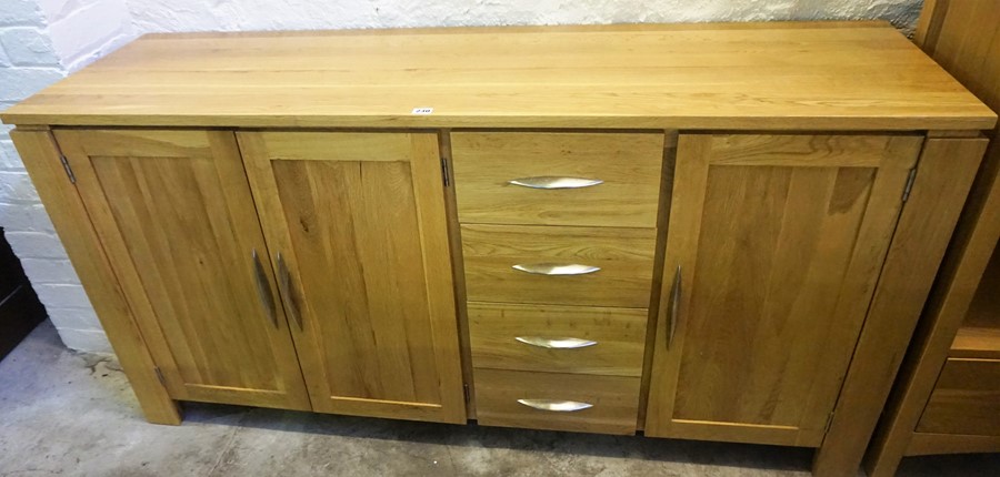 A Modern Light Oak Sideboard, With three doors, flanked with four drawers, 80cm high, 162cm wide,