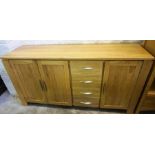 A Modern Light Oak Sideboard, With three doors, flanked with four drawers, 80cm high, 162cm wide,