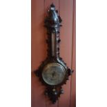A Black Forest Carved Wall Barometer, circa early 19th century, with a silvered thermometer guage