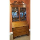 A Mahogany Inlaid Bureau Bookcase, circa early 20th century, With a swan pediment above two glazed