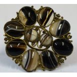 An Agate Brooch, Decorated with two small stones to the centre, flanked by eight larger stones,