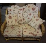A Wicker Six Piece Conservatory Suite, Comprising of a two seater sofa, three armchairs, stool and
