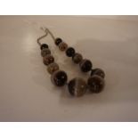 A Silver Mounted Necklace, Comprising of thirteen graduated agate style beads