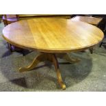 A Large Farmhouse Style Dining Table, The large circular top raised on a baluster column and