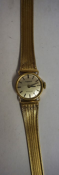 A Tissot Ladies Yellow Metal Wristwatch, With a silvered dial with baton numerals, 18cm long