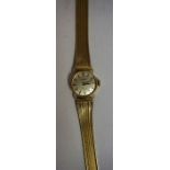 A Tissot Ladies Yellow Metal Wristwatch, With a silvered dial with baton numerals, 18cm long