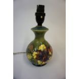 A Moorcroft Table Lamp, Probably in the Hibiscus pattern, on a green ground, 17cm high, with