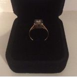 An Unmarked Gold Ladies Single Diamond Ring, Set in a square setting, probably Edwardian, ring size