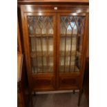 An Edwardian Mahogany Display Cabinet, With two glazed astragal doors enclosing a shelved