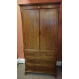 A Mahogany Linen Press, circa 19th century, With two large doors enclosing a shelved interior, above