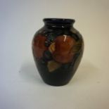 A Moorcroft Pomegranate Spill Vase, With allover decoration on a blue ground, 11cm high, a/f to