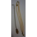 Three Strings of Synthetic Pearls, also with a pebble pendant on a white metal chain, (4)