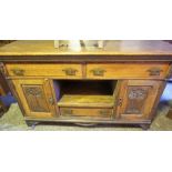 An Oak Sideboard, circa early 20th century, with fitted drawers above an open recess and cupboard
