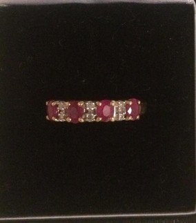 An Unmarked Gold Ladies Diamond and Ruby Dress Ring, Set with four rubies and three diamonds, ring