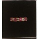 An Unmarked Gold Ladies Diamond and Ruby Dress Ring, Set with four rubies and three diamonds, ring