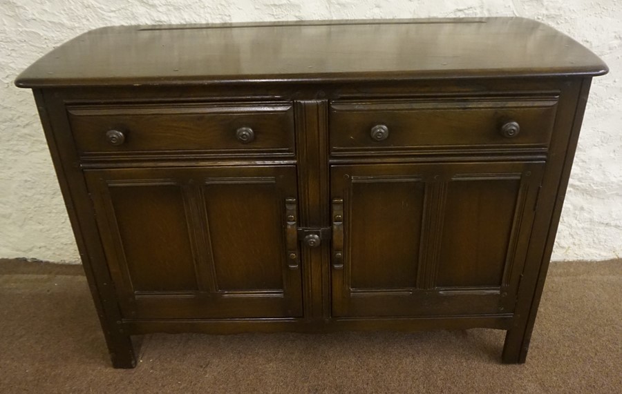 An Ercol Dresser Base, With two drawers above two doors, 84cm high, 123cm wide, 48cm deep