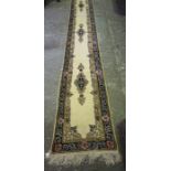 A Persian Style Floor Runner, Decorated with geometric medallions on a cream ground, approximately