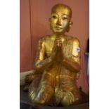 A Large Thai Gilded Wood Figure of a Monk, circa early 20th century, kneeling in prayer pose, a/f to