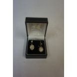 A Pair of Diamond Cluster Earrings, Set with a diamond stone above a cluster of approximately