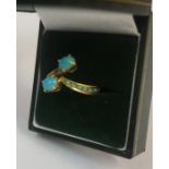 A 18ct Gold Turquoise and Diamond Ring, With two central turquoise stones, with five smaller