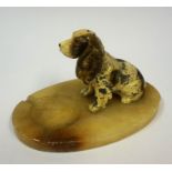 A Cold Painted Spelter Figure of a Dog, Raised on an onyx ashtray base, 15cm high