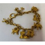 A 18ct and 9ct Gold Charm Bracelet, The chain stamped 18 to link, with eleven assorted gold