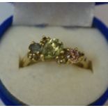 A Gold Gemstone Dress Ring, Set with a pink, green and blue gemstone, unmarked gold shank, overall