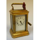 A Small Brass Cased Carriage Clock, The white enamel dial having Roman numerals, 10cm high, with