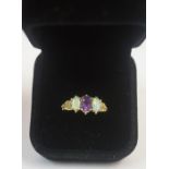 A 9ct Gold Opal and Amethyst Dress Ring, circa early 20th century, Set with an Amethyst stone,