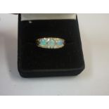 A 9ct Gold Opal and Diamond Three Stone Dress Ring, Set with three opals, and small diamond